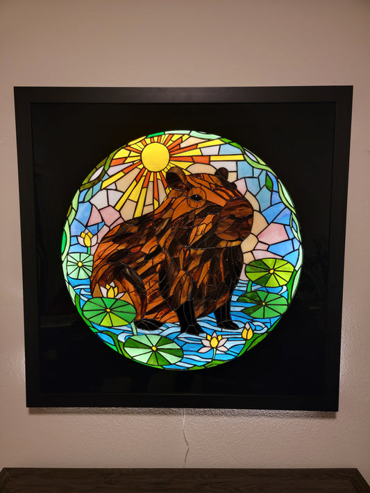 Striking handcrafted stained glass features a serene capybara resting in a pond